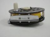 a close up of a small reel of yellow thread