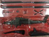 a toy army helicopter in a package on a table