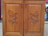 a wooden cabinet with two doors and flowers on it