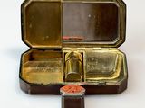 a small metal box with two compartments on a white surface