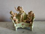 a figurine of a group of cherensils on a bench