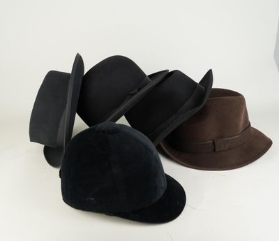 several hats are lined up on a white surface