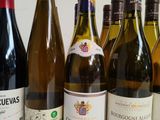 several bottles of wine are lined up on a table