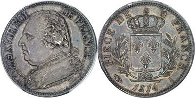 a silver coin with a crown on top of it
