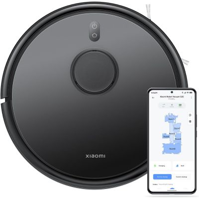 an image of a robot vacuum cleaner with a smartphone next to it