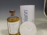 a bottle of liquid and a container of liquid on a table