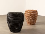 two black and brown vases sitting on top of a table