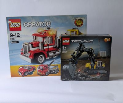 two boxes of lego creator construction vehicles and a box of construction vehicles