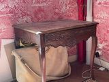a small table with a bag on it in a room