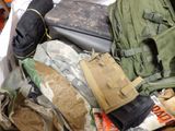 a pile of military gear on a bed