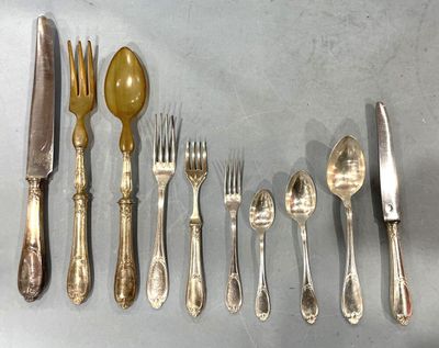 a lot of silverware on a table with a knife, fork, spoon, and spoon rest