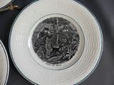 two plates with a picture of a man and a dog on them