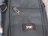 a small black bag with a red sport logo on it