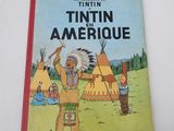 the tintin in the amerique book is sitting on a table