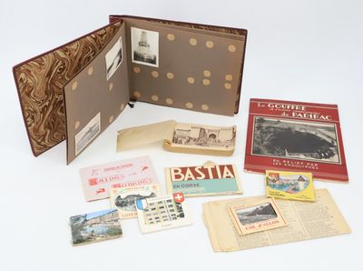 a lot of old books and postcards on the table