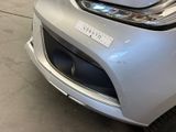 a close up of the front bumper of a silver car