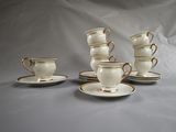 five cups and saucers sitting on a table