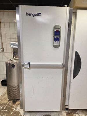a white refrigerator with a digital display on the door
