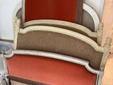a bed that has a red headboard on it
