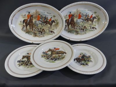 four plates with a picture of a group of people riding horses