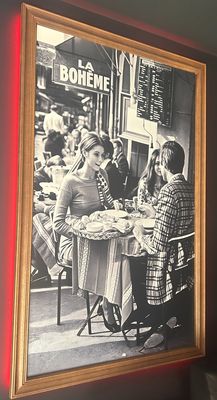 a picture of people sitting at a table in a restaurant
