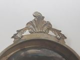 a silver plate with a bird on top of it