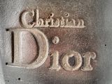 a close up of a metal object with the word christian dior written on it