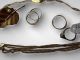 a lot of rings and bracelets that are on the table