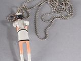 a necklace that has a figure on it and a ball chain