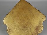 an image of a gold plate sitting on top of a table