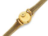a close up of a gold wrist watch with a chain around it