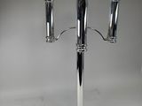 silver plated candelabra with three candles on a stand