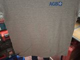 a man holding up a t - shirt in a store