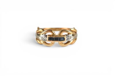 a close up of a gold ring with a blue stone in the middle