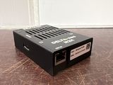 a close up of a small black box on a wooden table