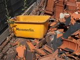 a yellow container sitting on top of a pile of bricks
