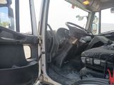 a view of the inside of a truck from the driver ' s seat