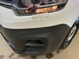 a close up of the front of a car with its lights on