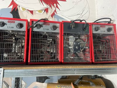 three red heaters on top of a shelf in a room