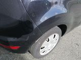 a black car that is parked on the side of the road