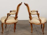 pair of french louis xv style walnut armchairs with upholstered upholstered arms