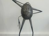 an image of a metal sculpture of a bird with a long beak