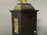 a black and gold clock with an angel on top