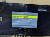 a flat screen tv sitting on top of a table
