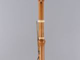 a close up of a musical instrument on a stand on a gray surface