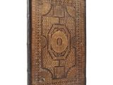an old book with a decorative design on the cover