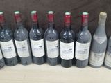 several bottles of wine are lined up in a row on a table