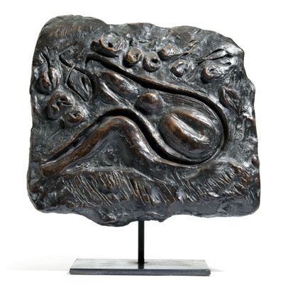 bronze sculpture of a lizard on a rock with a white background