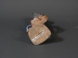 a small figurine of a man holding a bag