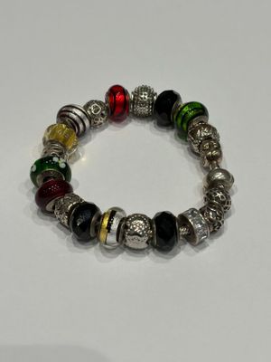 a close up of a bracelet on a white surface